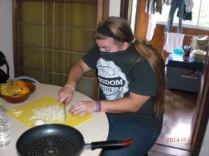 The GRITers help prepare food for the group each day. Amanda's eyes were bothered by the onions, so she tried a new method to counteract it!