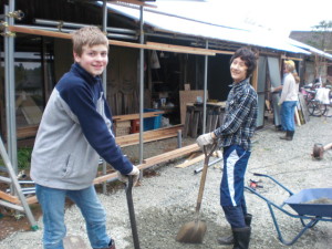 Cameron and Tango spreading gravel over the driveway