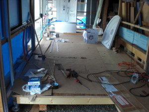 The floor is in. It is covered by linoleum...and flattened cardboard boxes so we can step on it with our dirty shoes!